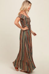woman wearing a colorful off-the-shoulder maxi dress with vertical stripes and a ruffled hem