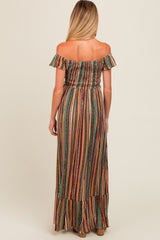 woman wearing a colorful off-the-shoulder maternity maxi dress with a smocked bodice and tiered hem