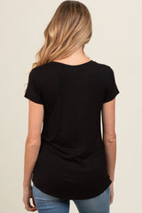 woman wearing a black short sleeve maternity top, viewed from the back, with a curved hemline and relaxed fit