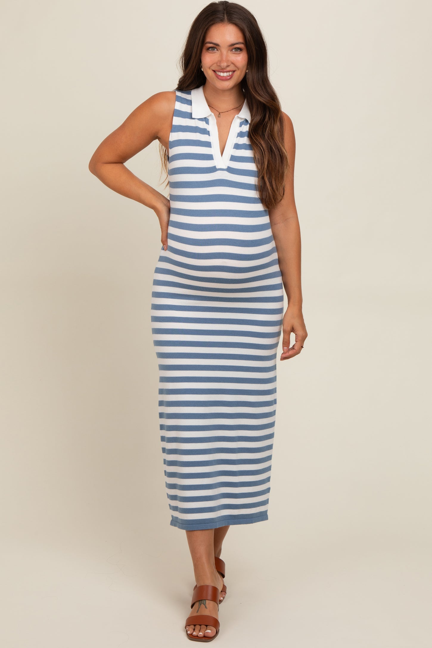 woman wearing a blue and white striped maternity maxi dress with a collared neckline and a visible baby bump