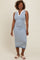 woman wearing a sleeveless striped midi dress in blue and white with a v-neckline