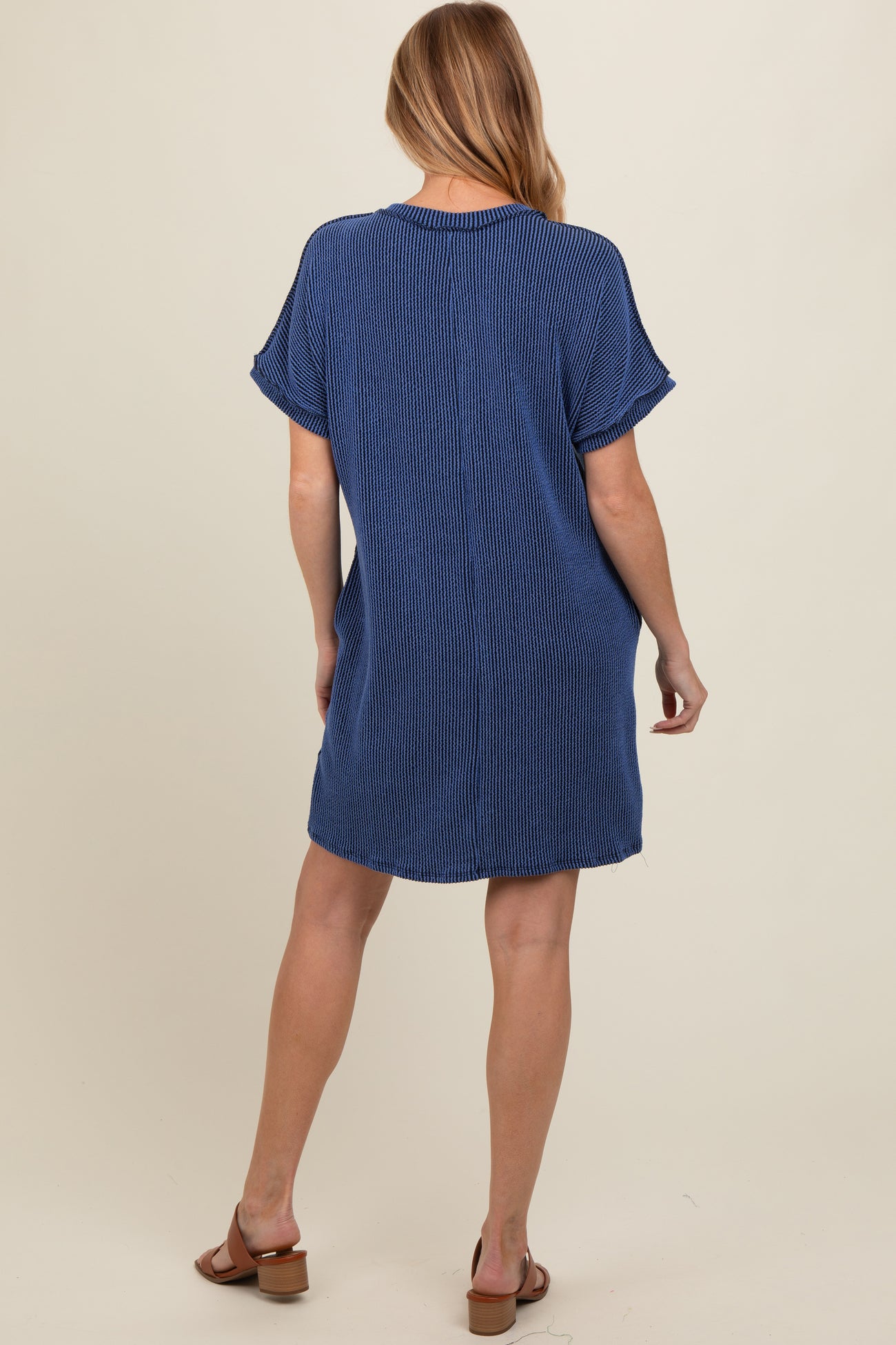 woman wearing a navy blue striped maternity dress with short sleeves and a relaxed fit