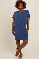 woman wearing a navy blue striped short sleeve dress with pockets and a relaxed fit