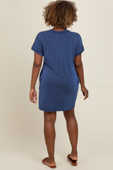 woman wearing a navy blue striped short sleeve dress, viewed from the back