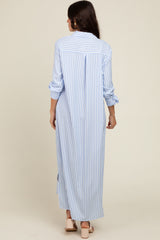 woman wearing a light blue and white striped long shirt dress with rolled sleeves and a back slit, viewed from behind