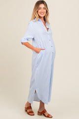 woman wearing a blue and white striped maternity dress with button details and pockets, featuring a visible baby bump