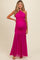 woman wearing a bright pink one-shoulder maternity gown with ruched details and a flowing skirt, showcasing her baby bump
