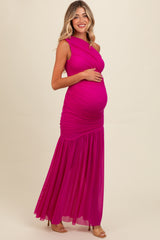 woman wearing a bright pink maternity gown with ruched detailing and a flowing skirt, revealing her baby bump