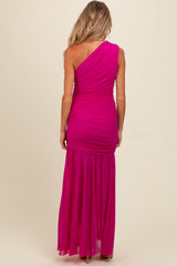 woman wearing a fuchsia one-shoulder maternity gown with ruched details and a flowing skirt, shown from the back