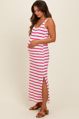 woman wearing a striped maternity maxi dress with a side slit and holding her baby bump