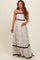 woman wearing a floral print maternity maxi dress with black trim and showing her baby bump