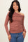 woman wearing a brown one-shoulder long sleeve top with ruching detail and styled with blue jeans