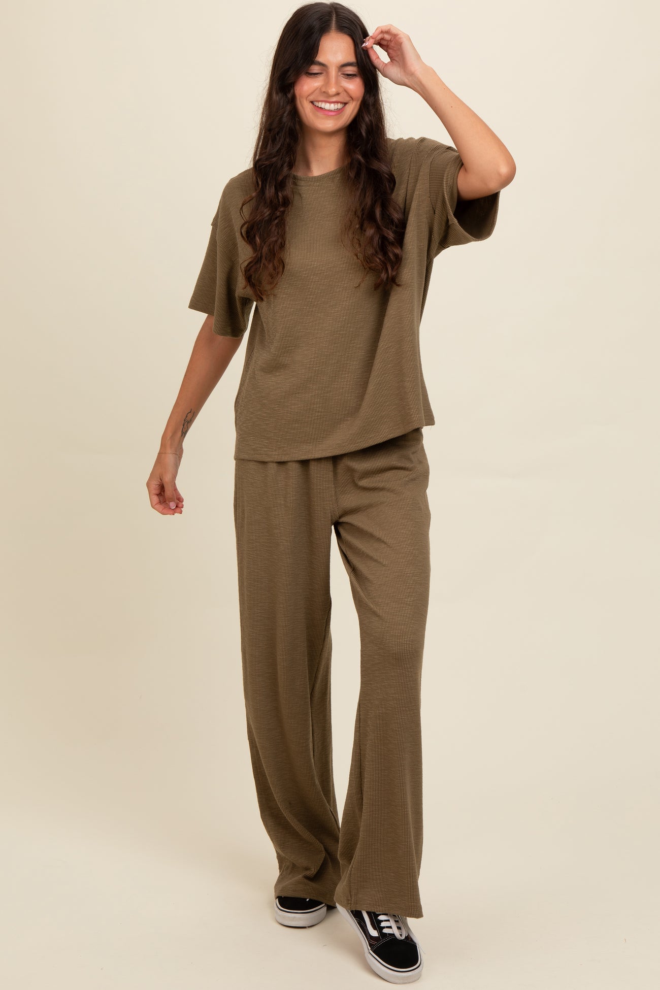 woman wearing an olive green ribbed knit oversized t-shirt and matching wide-leg pants