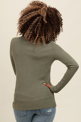 woman wearing an olive green ribbed long sleeve top, view from the back, paired with blue jeans