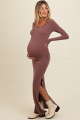woman wearing a ribbed mauve maternity dress with long sleeves and side slits, showcasing her baby bump