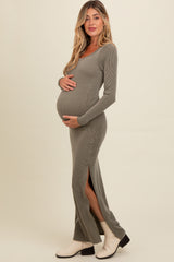 woman wearing a gray ribbed maternity dress with side slits, showcasing her baby bump