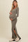 woman wearing a gray ribbed maternity dress with side slits, showcasing her baby bump