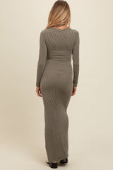woman wearing a dark olive green long sleeve ribbed maternity maxi dress, showing a visible baby bump from behind
