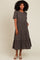 woman wearing a brown and black checkered tiered midi dress with short sleeves and a relaxed fit