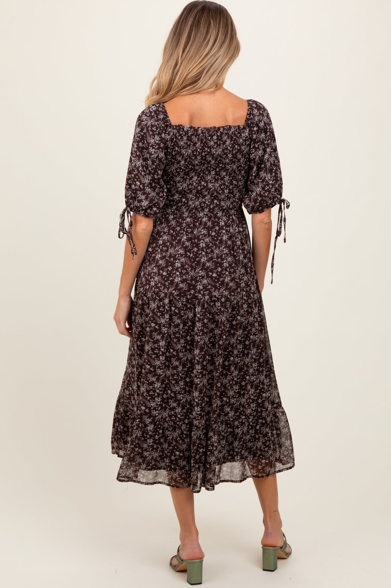 maternity wear black floral midi dress with puff sleeves and tie details at the cuffs, model shown from the back