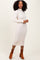 woman wearing a cream ribbed midi dress with long sleeves and matching ankle boots