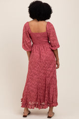 woman wearing a pink floral maxi dress with puff sleeves and a smocked bodice, viewed from the back