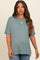 woman wearing a teal short sleeve maternity top with relaxed fit and a baby bump visible