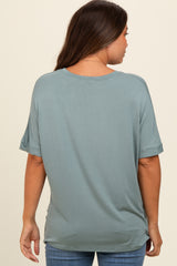 woman wearing a muted teal maternity top with short sleeves, seen from the back