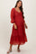 woman wearing a red tiered maternity dress with long puff sleeves and a sweetheart neckline, showing her baby bump