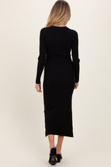 woman wearing a black ribbed long sleeve maternity dress from the back