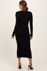 woman wearing a black ribbed knit midi dress with long sleeves, showing the back view and a fitted silhouette