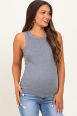 woman wearing a gray maternity tank top and showing her baby bump with distressed light blue jeans
