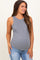woman wearing a gray maternity tank top and showing her baby bump with distressed light blue jeans