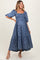 woman wearing a blue floral maternity maxi dress with square neckline and smocked bodice, showing baby bump