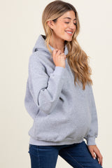woman wearing a gray maternity hoodie with a relaxed fit and a visible baby bump