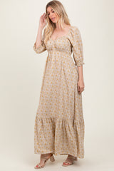 woman wearing a floral print long sleeve maxi dress with a sweetheart neckline and tiered hem