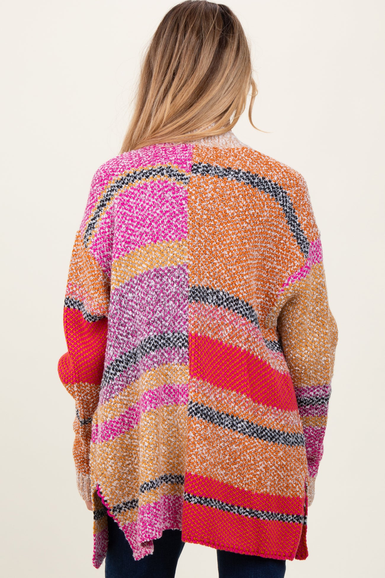 woman wearing a multicolored maternity cardigan with a loose fit and long sleeves, showing the back view