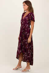 woman wearing a burgundy floral midi dress with a v-neck and short sleeves, tied at the waist