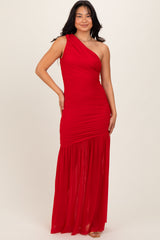 woman wearing a red one-shoulder maxi dress with ruching and a flowy skirt