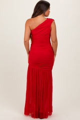 woman wearing a red one-shoulder maternity dress with ruching and a flowing skirt
