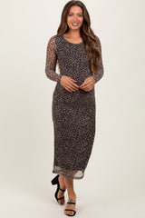 woman wearing a long sleeve leopard print maternity dress, showcasing her baby bump while posing confidently