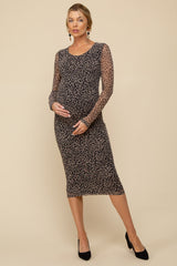 woman wearing a black leopard print maternity dress with long sleeves and a baby bump