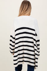 woman wearing a black and white striped oversized maternity sweater, view from the back