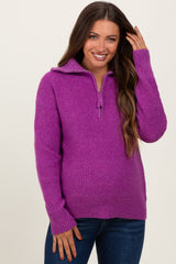 woman wearing a purple zip-up knitted maternity sweater with long sleeves and a relaxed fit