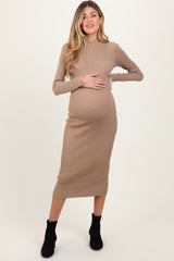 woman wearing a beige ribbed long sleeve maternity dress and holding her baby bump