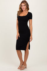 woman wearing a black ribbed midi dress with short sleeves and side slits