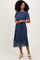 woman wearing a navy blue floral midi dress with short sleeves and a tie waist detail