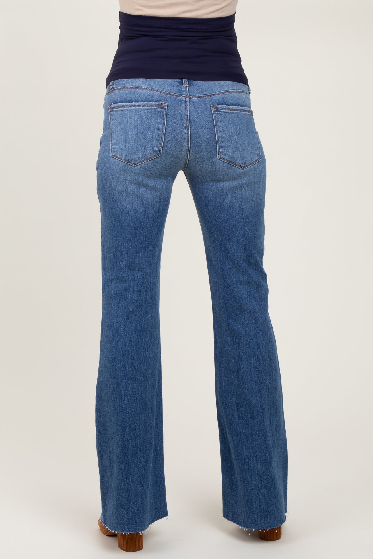 maternity wear, woman wearing blue flare leg jeans viewed from the back