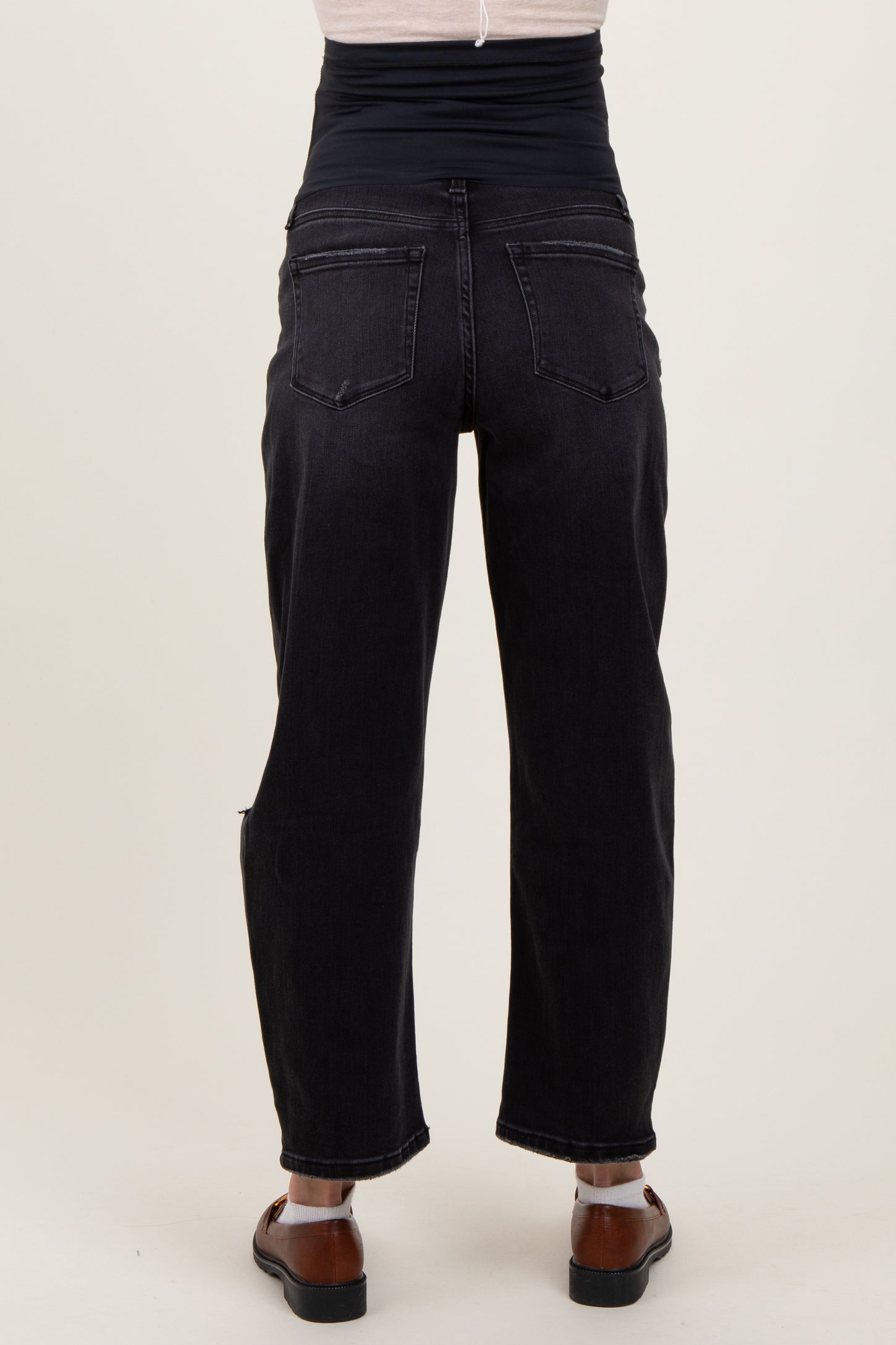 woman wearing black maternity jeans with a high waistband, showing the back view