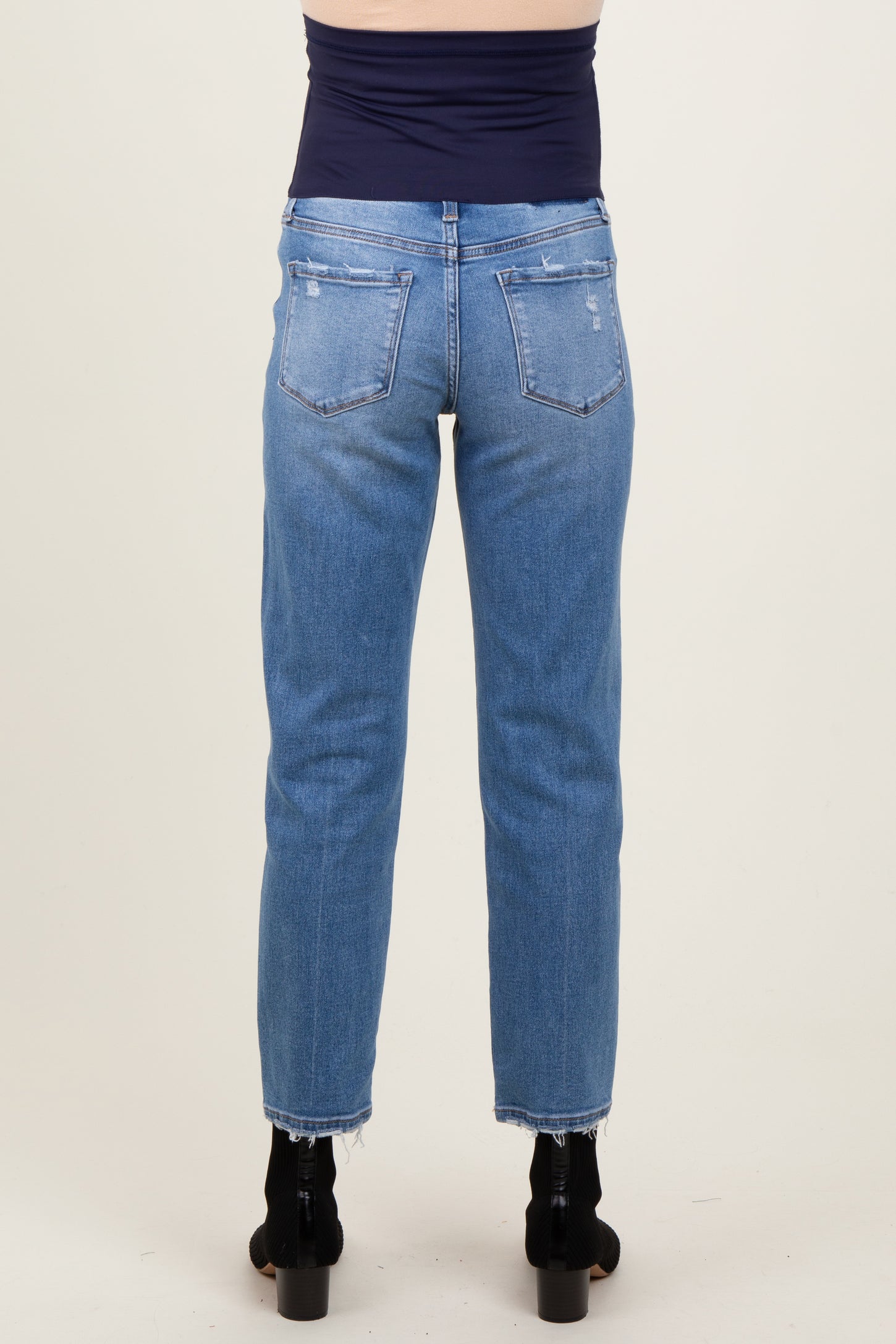 maternity wear light wash straight leg jeans with a raw hem, model shown from the back